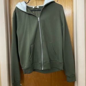 Olive green zip-up jacket.